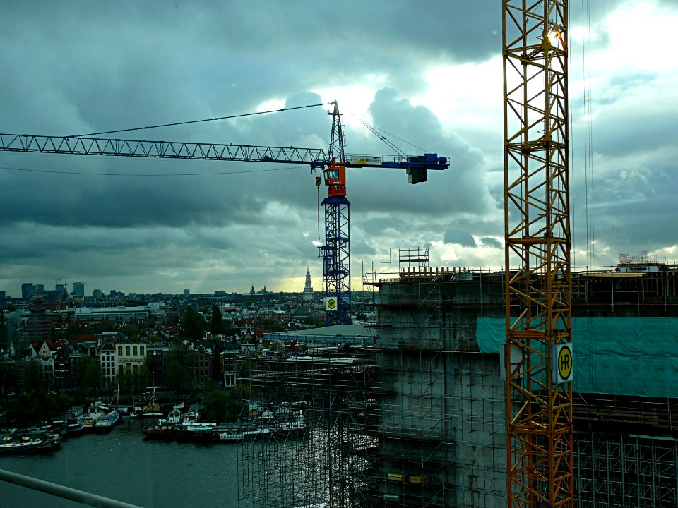 2006.10 - 'Building to the sky' - Amsterdam photos and pictures, construction-site in light of late afternoon sky in Fall above the city with cranes at the Oosterdok; Dutch city + geotag, Fons Heijnsbroek, The Netherlands photo
