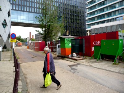 Woman walking in front of the construction site of The Gate and main building of the university, Amsterdam; photography of modern Dutch architecture in The Netherlands, Fons Heijnsbroek photo