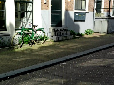 2013.04 - 'A view over a small connecting street Tussen-Kadijken', with sun-light and shadows on the pavements and walls, Spring, Amsterdam city; urban photography Fons Heijnsbroek photo