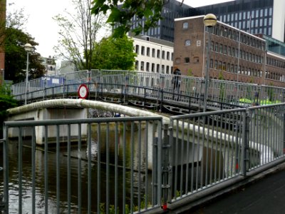 On the footbridge over the canal Nieuwe Achtergracht to college on the campus Roeterseiland in Amsterdam; the university area; urban photography of The Netherlands, Fons Heijnsbroek photo