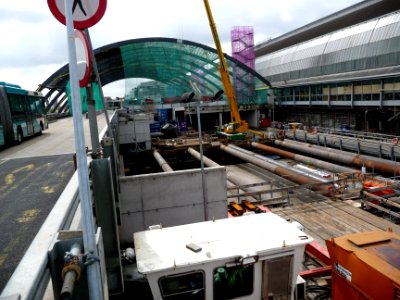 2011.06 - 'A view over the new-built bus-station', with the bowed glass-roof and with the concrte metro tunnel underground, direction  behind Central Station Amsterdam - east-side of the station; urban photography, Fons Heijnsbroek