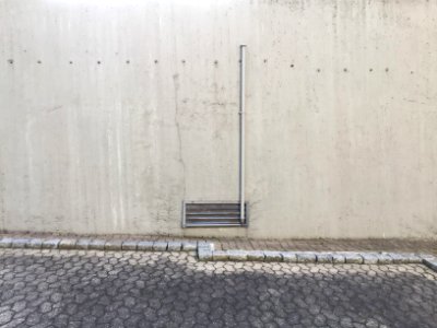 Parking lot with concrete wall and metal blends