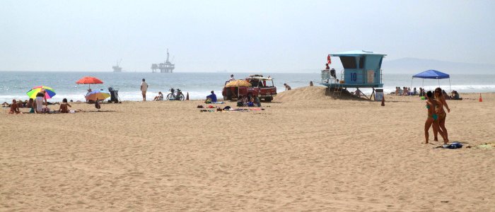 Plage avec vue sur forage pétrolier