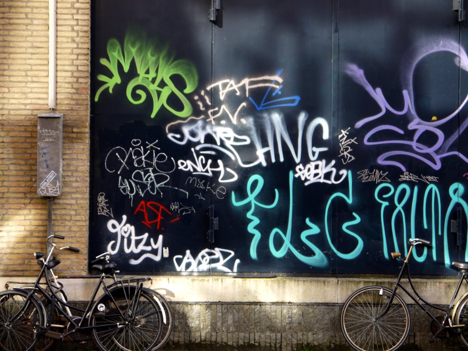 Urban collage: collection street graffiti tags on a nice dark-green background-wall in sunlight and shadow on Hoogtekadijk; photo Amsterdam city; urban photographer Fons Heijnsbroek, 2013