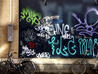 Urban collage: collection street graffiti tags on a nice dark-green background-wall in sunlight and shadow on Hoogtekadijk; photo Amsterdam city; urban photographer Fons Heijnsbroek, 2013