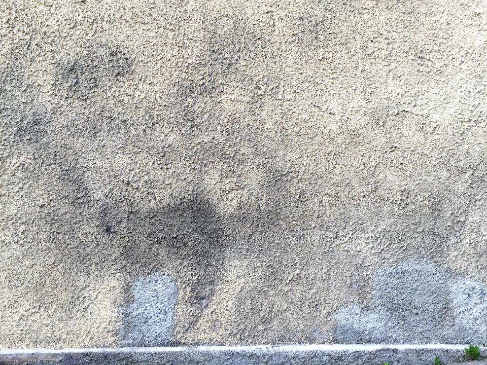 Old plastered wall with paint spots
