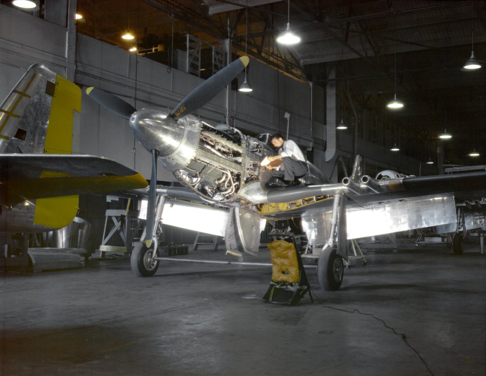 An inspector looks over a Mustang Mk I fighter
