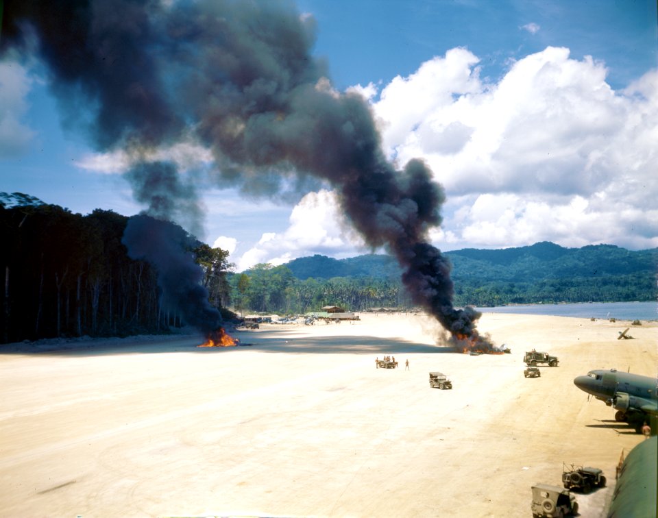 Wreckage burns from two Marine F4U Corsairs