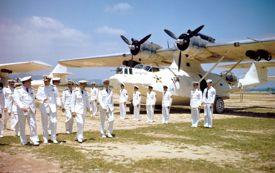 U.S. Navy officers review a line of Brazilian PBY-5A amphibians with Brazilian naval aviators