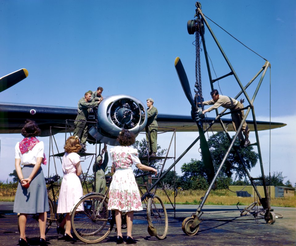 English women watching Air Force maintenance crew