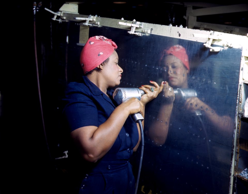 A riveter works on a Vultee A-31 Vengance