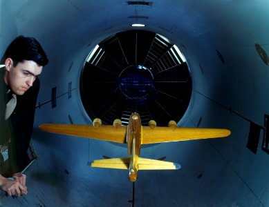 Army Air Forces engineer examines a B-17