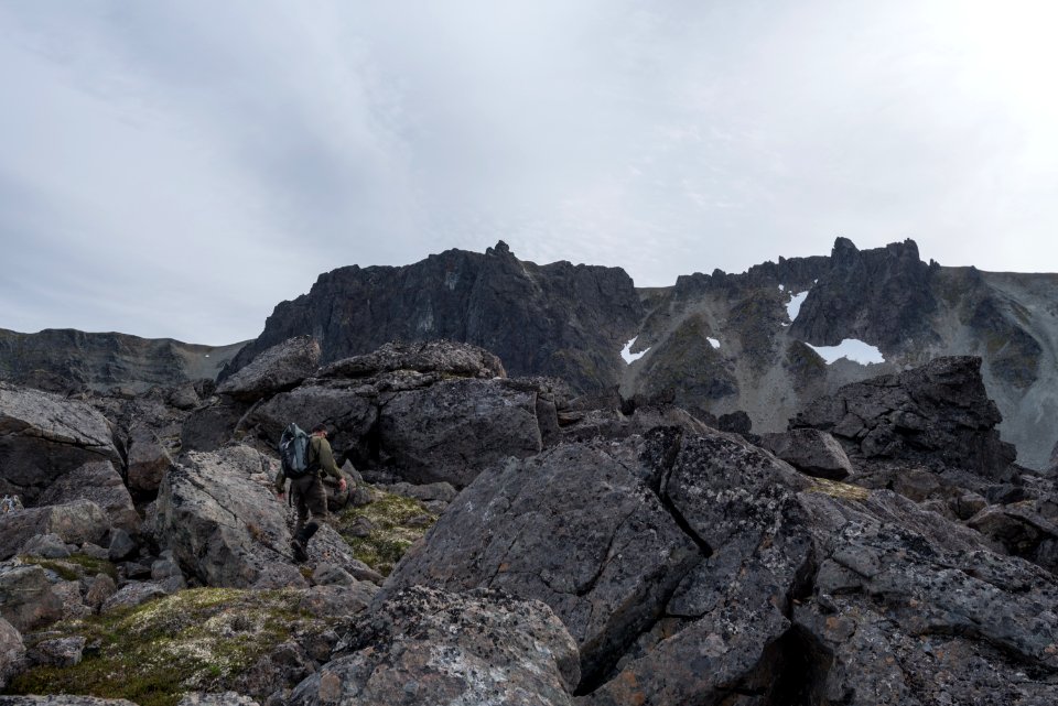 A park ranger walks through moss covered rocks in the Katmai Preserve NPS Photo/Russ Taylor