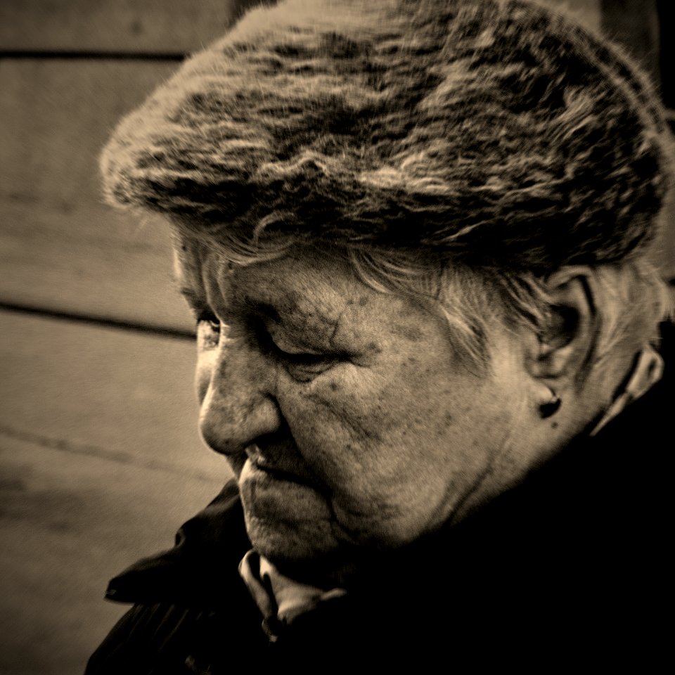 Elderly Woman at Tram Stop