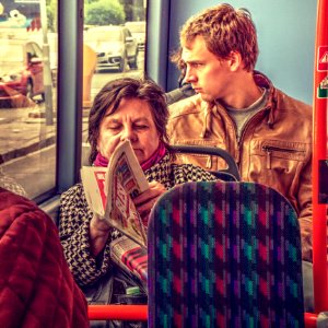 Woman Reading a Tabloid in the Bus 1 photo