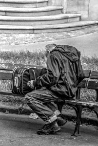 Man with Case on a Bench photo