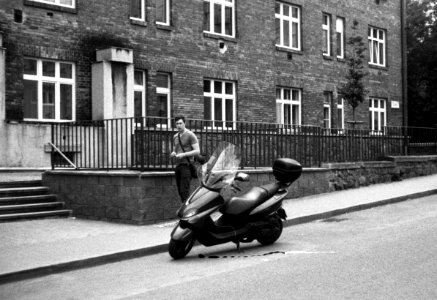 Vilia - Man Leaving His Scooter on Slightly Damaged Film photo