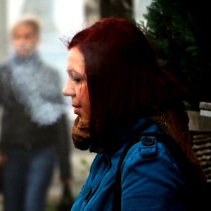 Young Woman Waiting for a Bus in Misty Morning photo