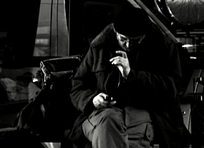 Man Texting at Night Bus Stop 2 photo