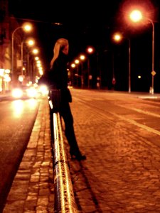 Young Woman Waiting for a Tram at Night photo