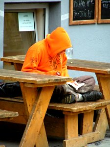 Reading Man in Orange Hoodie photo