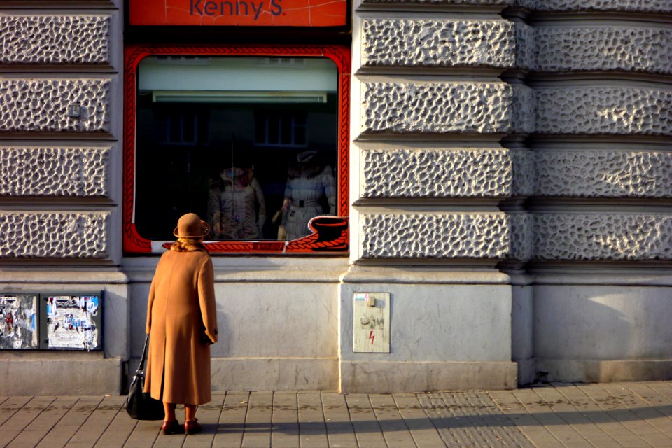 Old Woman Looking at Shop Window
