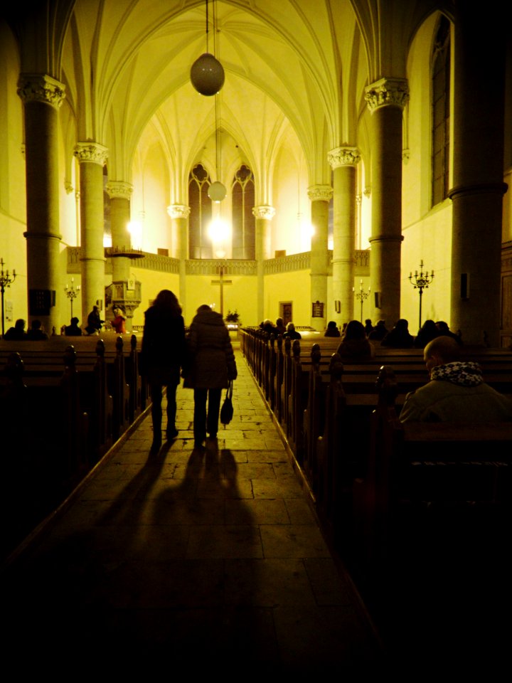 People Entering the Red Church in Brno