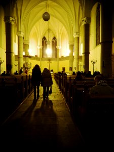 People Entering the Red Church in Brno