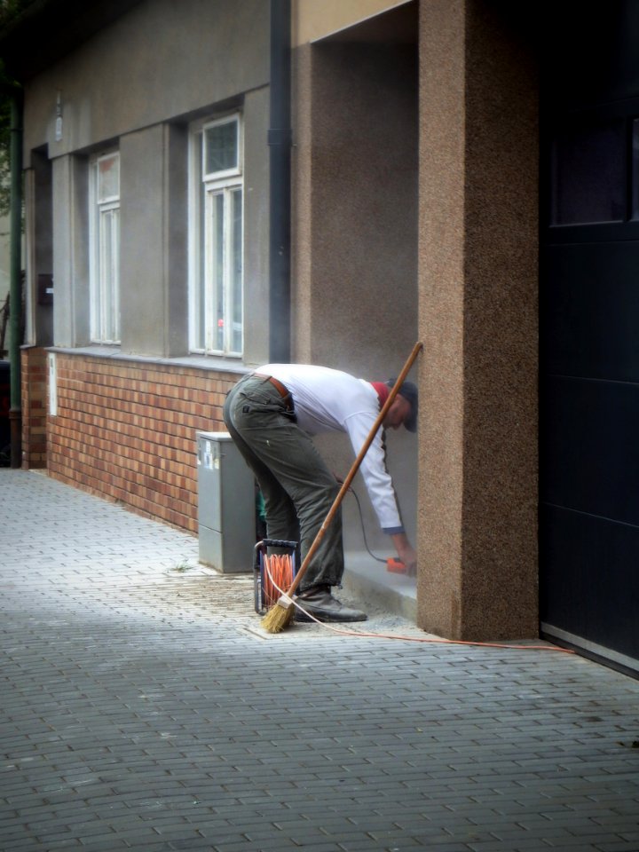 Man Working  in front of His House