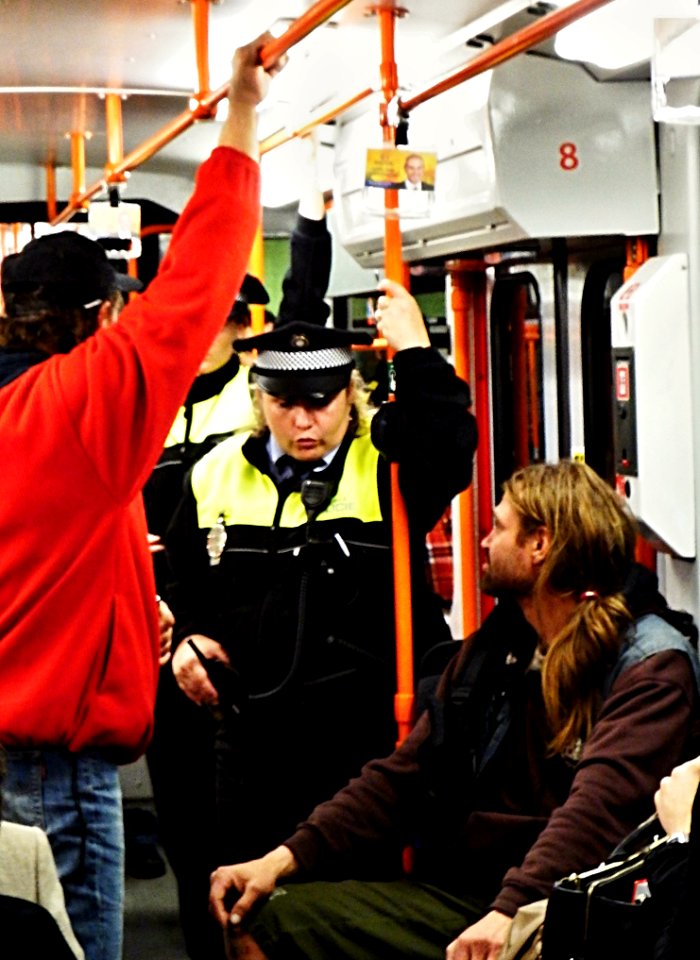 Man Discussing Some Problem with Policewoman in the Tram