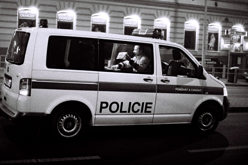 Canon EOS 30 - Man with Paper in a Police Car