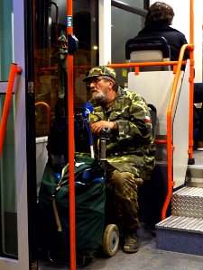 Noticeable Man in Camouflage Suit in the Tram photo