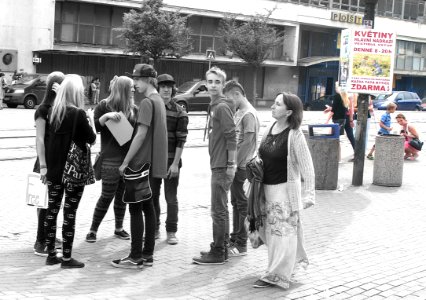 Lady Looking at Youth on Tram Stop photo