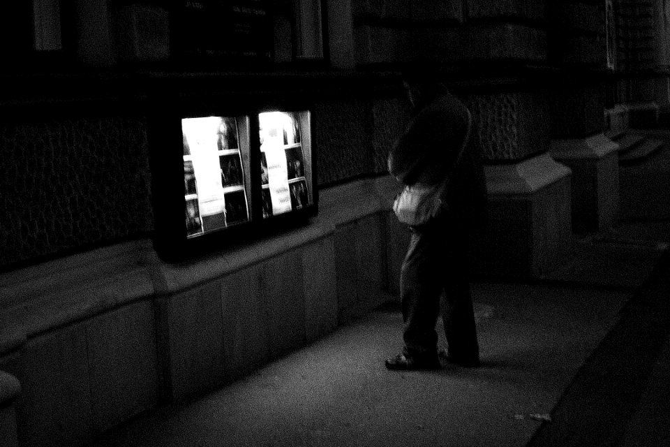 Man Looking at Theatre Notice Board