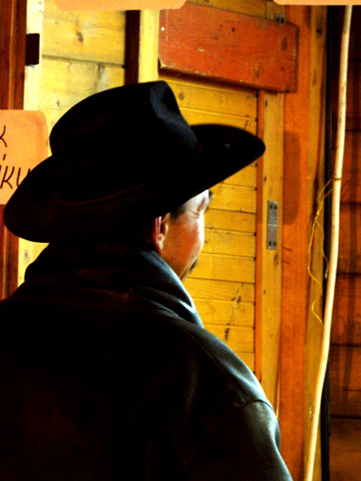 Man in Hat at the Stand 2