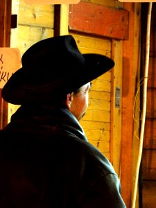 Man in Hat at the Stand 2