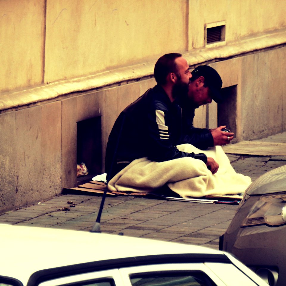 Homeless men Sitting next to the Hospital photo