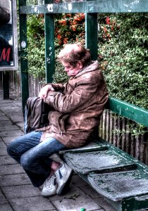 Man Sleeping at the Bus Stop
