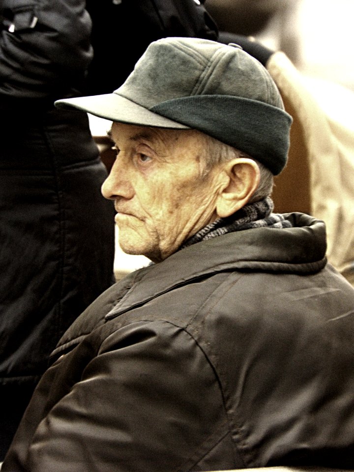 Old Man at Tram Stop Bench 1
