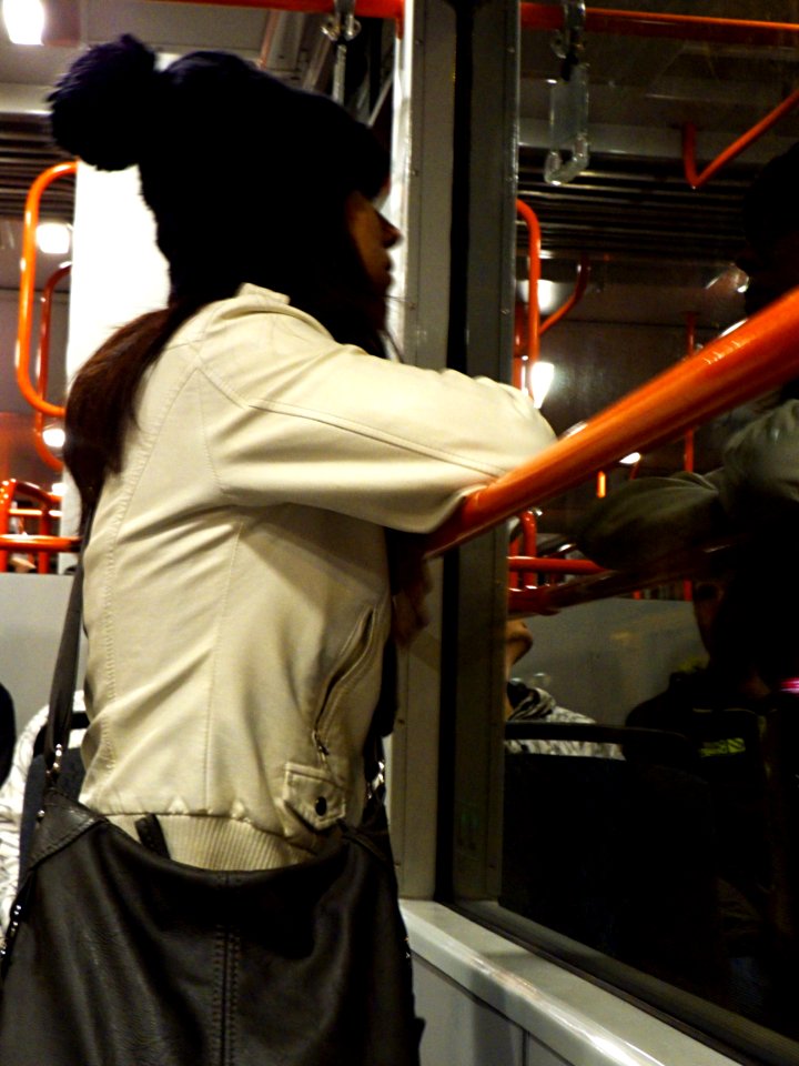 Girl Looking from Tram Window to the Night