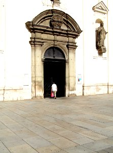 Elderly Woman Entering the Church of St. Thomas photo