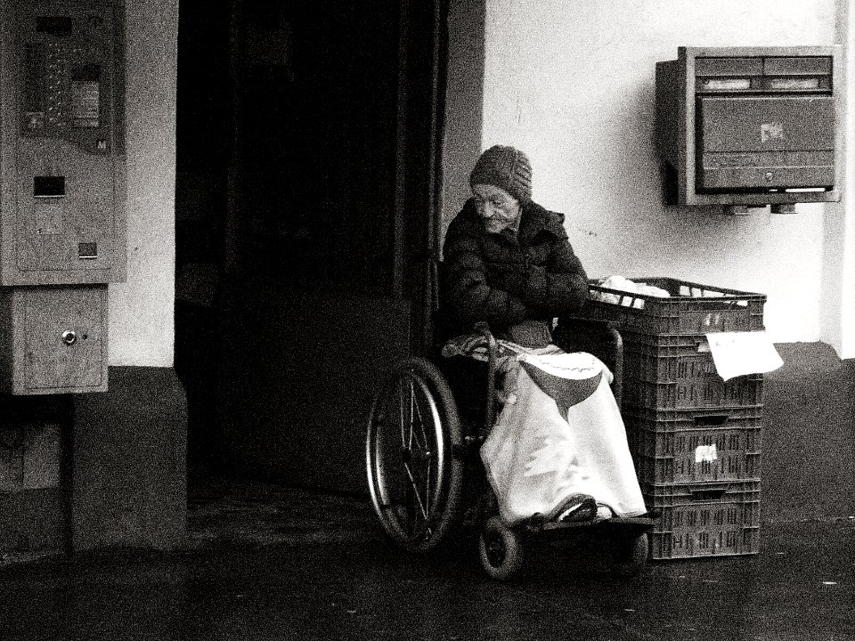Old Woman in front of the Store