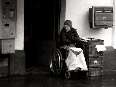 Old Woman in front of the Store