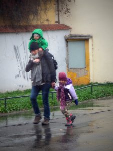 Father and Children in a Rainy Day