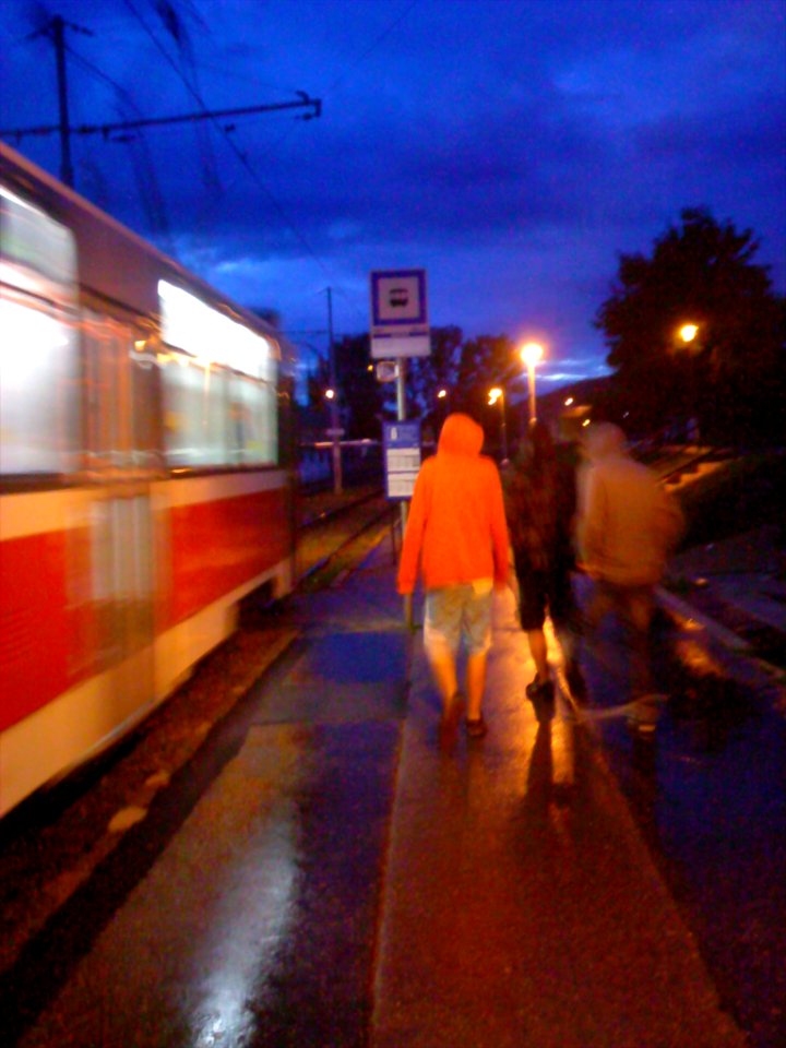 Man in Orange at Tram Stop