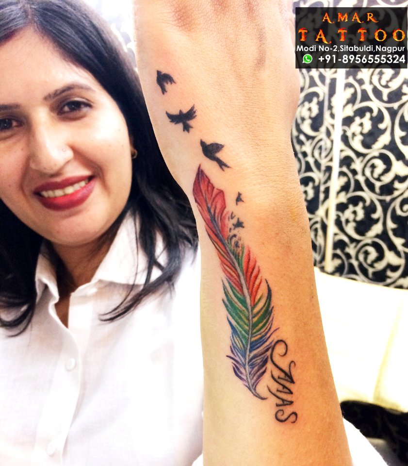 feather tattoo on side wrist