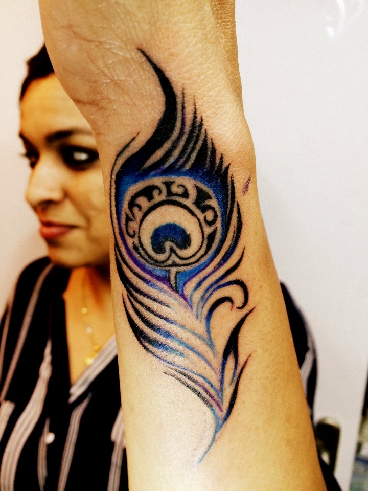 feather tattoo on wrist