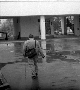 Ricoh TLS 401 with Helios 44-2 - Man Walking in Rainy Day