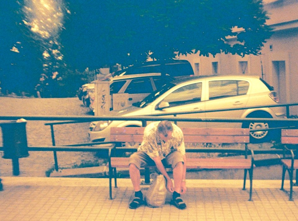 Vilia-Auto - Redscale - Man Fixing his Socks