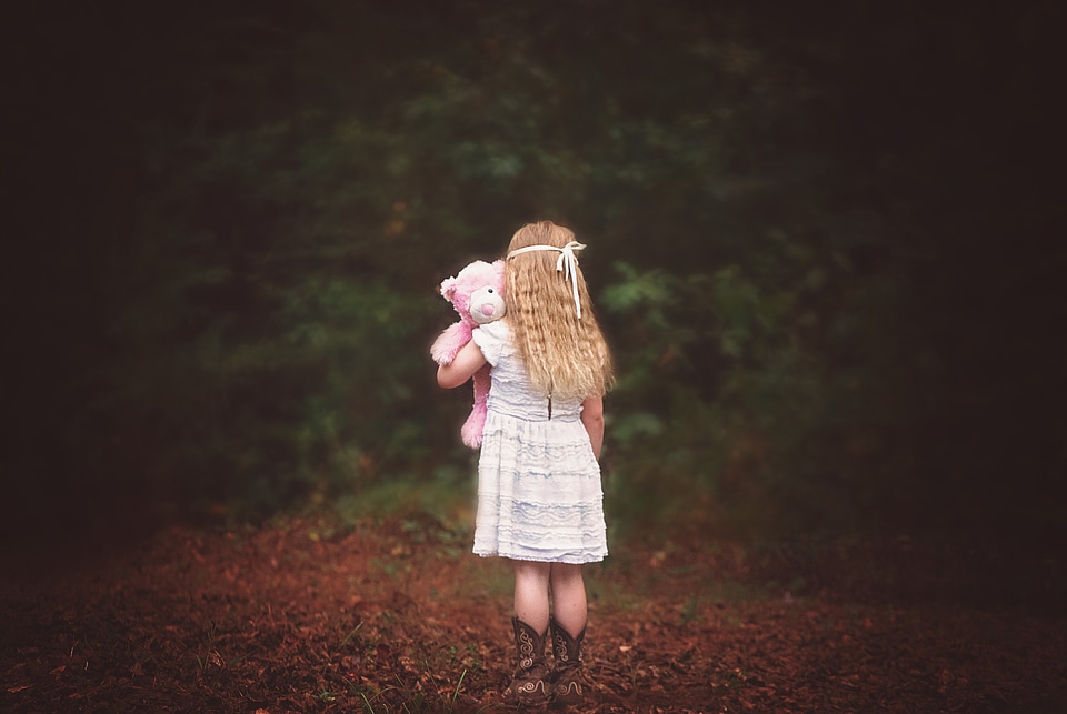 Looking away child teddy bear